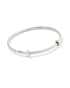 A minimalist and elevated charm base featuring two removable spacers for maximum versatility. Designed to capture your favorite charms, the Charm Bangle Bracelet in Sterling Silver is an essential for anyone with a growing charm collection or interested in adding some personality to their stack. 

 Please note: Additional charm spacers are sold separately. Modern Adjustable Charm Bracelet With Extender, Everyday Bangle Charm Bracelet With Extender, Adjustable Modern Charm Bracelet For Everyday, Modern Adjustable Charm Bracelet, Adjustable Classic Charm Bracelet For Everyday, Adjustable Classic Charm Bracelet, Modern Adjustable Hypoallergenic Charm Bracelet, Adjustable Sterling Silver Charm Bracelet Modern Style, Adjustable White Gold Charm Bracelets