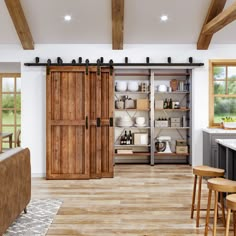 a large open kitchen with sliding doors and wooden flooring in the center, next to an island