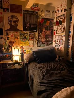 a bedroom with posters on the wall and a bed