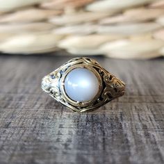 Antique 1846 Victorian Moonstone Cabochon Ring with Black Enamel in 18k Yellow Gold | Mourning Ring | Memorial Jewelry Phenomenal estate moonstone ring for the discerning collector.  This late Georgian/ Early Victorian era piece is fashioned from substantial 18k yellow gold, and features a cabochon cut moonstone with black enamel detailing.  The moonstone has a creamy color with grays. This is a memorial ring and the inscription reads: Robert Burra born 25 april 1767, died 28 Jan 1846. DETAILS/MEASUREMENTS: Moonstone - about 8 mm  Face - 13.5 mm wide in the center Shank - 3.10 mm in back Height- 8.15 mm Weight -6.36 grams Hallmarks/Stamps - Faded/partial London mark and partial mark remaining of Victoria duty for 18k gold.  Currently a size 9- Can be resized by your jeweler or by ours for Luxury Vintage Moonstone Oval Cabochon Ring, Luxury Antique Cabochon Pearl Ring, Luxury Engraved Oval Cabochon Jewelry, Elegant Round Cabochon Signet Ring, Yellow Gold Oval Cabochon Moonstone Ring, Formal 14k Gold Oval Cabochon Moonstone Ring, Hallmarked Yellow Gold Moonstone Ring, Classic Cabochon Moonstone Ring, Heirloom Style Yellow Gold Moonstone Ring