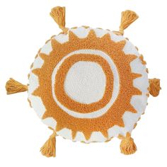 an orange and white round rug with tassels on the bottom, in the shape of a sun