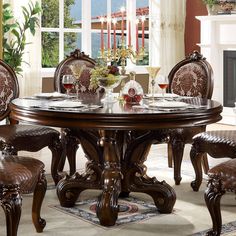 a dining room table with chairs around it and a fire place in the corner behind it