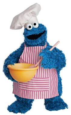 the cookie monster is wearing an apron and holding a bowl with a spoon in it