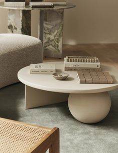 a coffee table with books on it in a living room