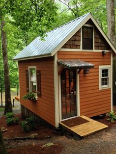 a small orange cabin in the woods