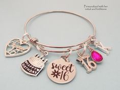 "16th Birthday Gift for Girl Our sweet 16 personalized charm bracelet- comes with all charms shown, you just select the initial and birthstone you need. Ships within two business days from Bangor, Maine The bangle is adjustable to fit most wrist sizes and is made of jewelry grade stainless steel. Stainless steel bracelets are always our choice for expandable bracelets. Stainless steel ensures your bracelet will never tarnish or lose it's color - it's also easy to care for. Just a quick polish wi Birthday Round Charm Bracelet, Hypoallergenic Charm Bracelet For Birthday And Valentine's Day, Hypoallergenic Charm Bracelet For Birthday, Adjustable Charm Bracelet For Birthday Valentine's Day, Adjustable Charm Bracelet For Birthday And Valentine's Day, Adjustable Name Bracelet With Charms For Birthday, Silver Round Name Bracelet For Birthday, Hypoallergenic Charm Bracelet For Birthday And Mother's Day, Personalized Pink Charm Bracelet For Anniversary