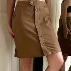 Awesome Skirt For The Office, Class, Vacation, Or A Casual Hike It Has Pockets! Kind Of A Dark Camel /Cafe Au Lait Sort Of Color The Pictures Where Model Is Wearing Are Truest To Color. Faux Tortoiseshell Buttons Complement The Tan Color Size Xs Shown On 6/8 5’8” 34”-29”-37”Runs A Bit Big Never Worn, New With Tags Including The Spare Bag O Buttons Viscose Rayon / Nylon / Spandex Blend Pencil Skirt A Line Professional Job Interview Academia Bougie Old Money Look Aesthetic Sporty Coastal Chic Vani Brown Knee-length Skirt With Button Closure, Knee-length Skirt With Side Buttons For Work, Fitted Cargo Skirt With Button Closure, Fitted Workwear Skort With Button Closure, Fitted Skort With Button Closure For Work, Workwear Mini Skirt With Side Buttons, Beige Relaxed Skirt With Button Closure, Fitted Cargo Skirt With Button Closure For Spring, Brown Mini Skirt With Button Closure For Work