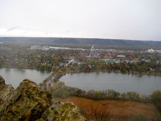 an aerial view of a lake and city in the distance