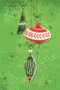 two christmas ornaments hanging from strings on a green background with snowflakes and stars