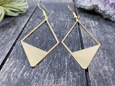 "These geometric statement earrings feature 56mm x 27mm raw brass geometric diamonds. These minimalist geometric earrings will complement any outfit, and are lightweight enough for all day wear! The earrings measure approximately 2 15/16 inches from the bottom of the diamond to the top of the ear wires, which are made of hypoallergenic gold-plated surgical steel, making them safe for sensitive ears. These earrings are very lightweight, each weighing 0.1 ounce. Domestic shipping is always free he Everyday Single Geometric Earring, Everyday Geometric Single Earring, Modern Gold Geometric Earrings, Modern Geometric Gold Earrings, Geometric Metal Earrings With Ear Wire, Gold Geometric Jewelry With Matching Earrings, Modern Gold Diamond-shaped Earrings, Gold Geometric Earrings For Everyday, Geometric Metal Earrings For Everyday