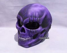 a purple skull mask on a white background