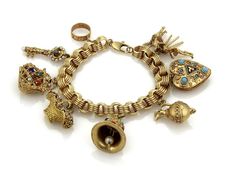 "Material: 14k yellow gold Measurement: 7.5\" long and 7mm wide x 7mm high Charms varies in sizes from: 1\" x 1\" - 1/2\" round Gemstone: Sapphire, turquoise, pink tourmaline, seed pearl and coral Weight: 89.7 grams This hefty vintage charm bracelet is crafted from solid 14k yellow gold and is stunning with the nine charms dangling from a wide grooved chain links. The charms are a heart locket with turquoise, a painter with the model, a basket of flowers, a gemstone decorated purse, a bell wit g Solid Gold Charms, Basket Of Flowers, Slide Bracelet, Vintage Charm Bracelet, Bracelet Box, Charms Bracelet, Gold Charm Bracelet, Chain Links, Fine Jewelry Bracelets