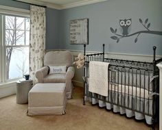 a baby's room with an owl decal on the wall and a rocking chair