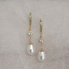 "* Beautiful gold wire wrapped Swarovski Pear Pearl dangle earring accented with a gold-filled bead cap and complimented a cubic zirconia center piece bead and hung from a cubic zirconia ear wire. This pair of earrings measure approximately 1 3/8\". * Also, available in Swarovski Pearls ~ White (shown), Cream (shown), Cream Rose, Light Gold, and Rose Gold. * Matching bracelet (shown in the 5th picture)~ https://www.etsy.com/listing/783225489/wedding-jewelry-for-brides-swarovski * TAKE 10% OFF $7 Gold Pearl Drop Earrings For Mother Of The Bride, Gold Teardrop Pearl Drop Earrings For Wedding, Gold Teardrop Wedding Earrings With Pearl Drop, Gold Dangle Teardrop Earrings For Bridesmaid Gift, Gold Dangle Pearl Earrings For Bridesmaids, Elegant Wire Wrapped Crystal Earrings, Gold Pearl Bridal Earrings For Bridesmaid Gift, Gold Teardrop Bridal Earrings For Mother Of The Bride, Elegant Gold Crystal Earrings Wire Wrapped