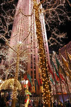 christmas lights adorn the tall building at night