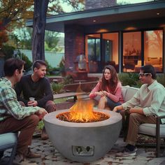 four people sitting around an outdoor fire pit