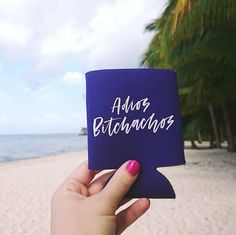 a person holding up a blue coaster with the words abos bataandos written on it