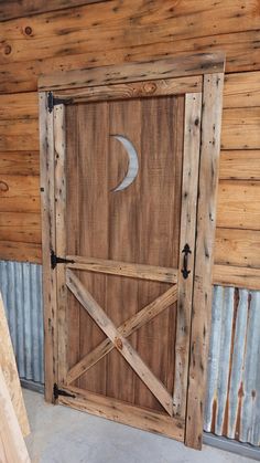 an open wooden door with a half moon on it