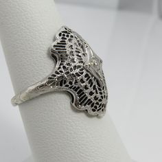 Art deco 14k white gold. estate 1920's diamond ring. size 6.75. quality clean 5pt diamond . great shape. mark 14k. 2.9grams. 2omm long. Vintage White Gold Filigree Jewelry, White Gold Filigree Jewelry For Vintage Events, Art Deco White Gold Rings Stamped 14k, White Gold Art Deco Rings Stamped 14k, Ornate White Gold Engraved Rings, Silver 14k Gold Art Deco Diamond Ring, Art Deco Silver Diamond Ring In 14k Gold, Antique Engraved White Gold Filigree Ring, Classic Engraved Ring With Intricate Design For Collectors