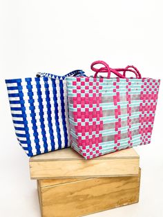 Add some serious sass to your beach game with our Summer Tote Bags. With two color options, this woven bag is the perfect accessory for a day by the water. Stay stylish and organized while carrying all your beach essentials. (No more losing your sunglasses in the sand!) Hot pink, clear, & aruba blue Blue & white Free shipping over $100. Pink Woven Beach Bag, Pink Woven Beach Bag For Summer, Pink Woven Bags For Beach Season, Eco-friendly Pink Beach Bag For Beach Season, Blue Plastic Beach Bag, Pink Eco-friendly Beach Bag, Blue Plastic Beach Bags, Eco-friendly Pink Beach Bag, Blue Basket Bag For Vacation