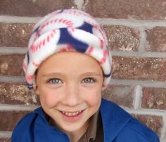 a young boy wearing a baseball themed hat