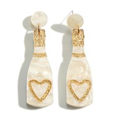 two white and gold earrings with hearts on them