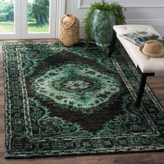 a large rug with an ornate design on the floor in front of a door and window