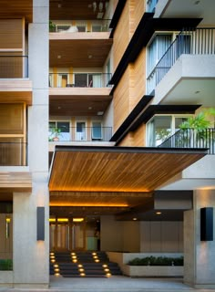 an apartment building with balconies and stairs leading up to the second story area