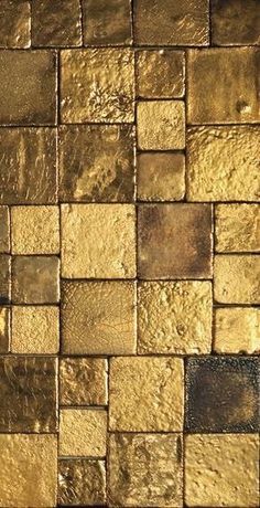 a close up view of some gold colored tiles