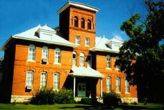 an old red brick building with a clock tower