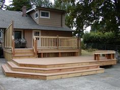 a wooden deck with steps leading up to a house