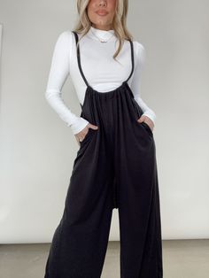 Get ready for a comfy, casual slay with the Alexis Jumpsuit! This cosy knit piece is oh-so-stretchy, giving you a figure-flattering fit that moves with you. Plus, it’s complete with adjustable suspenders straps, a low cut, and a wide-leg fit, making it both trendy and versatile. This chic jumpsuit has it all - comfort, pocket details, and layering capabilities - making it an everyday wear essential! Morgan is shown wearing a size small. 62% Polyester 33% Rayon 5% Spandex Machine wash cold Fitted Black Jumpsuit For Lounging, Black Lounging Jumpsuits And Rompers For Spring, Casual Winter Loungewear Jumpsuits And Rompers, Black Stretch Jumpsuits And Rompers For Loungewear, Chic Winter Jumpsuits And Rompers For Loungewear, Casual Loungewear Overalls, Comfortable Fall Loungewear Jumpsuits And Rompers, Black Stretch Cotton Jumpsuits And Rompers, Jumpsuits And Rompers For Lounging In Fall