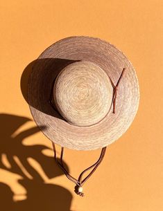 A sustainable and practical essential for warm sunny days, the Nelly hat is handmade from ethically grown palm leaves. With a sturdy brim and an open lattice design circling the top (allowing for ventilation during those humid summer months), this sun hat is the perfect finishing touch with jeans and a tee or pair it with your favorite sundress for a day in the park. Hand woven palm Fair Trade 100% natural palm leaf, grown in Mexico UPF50+ Water resistant Approx 3 1/2" brim Grosgrain inner band Adjustable Open Weave Sun Hat For Beach, Adjustable Open Weave Summer Straw Hat, Adjustable Summer Straw Hat With Open Weave, Artisan Boater Hat With Curved Brim For Beach, Woven Palm Leaf Boater Hat For Vacation, Spring Adjustable Natural Fiber Straw Hat, Adjustable Natural Fiber Straw Hat For Spring, Artisan Woven Straw Hat For Summer, Eco-friendly Palm Leaf Straw Hat For Beach