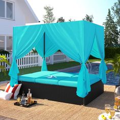 a blue canopy bed sitting on top of a patio