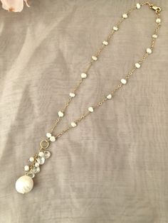 Simple and pretty freshwater pearl necklace, perfect for everyday wear. Pearls are large (12-14MM) round, white, which are slightly graduated in size. Some pearls contain irregularities, due to the organic nature of pearls.Five pearls are centered on the 3MM 14 GF cable chain.The necklace length is 19 1/4, but can be made shorter. A jump ring at the end of the necklace has a small (8MM) round white pearl to accentuate the closure, which is a 10MM 14K GF lobster clasp.All 14K GF and vermeil findi Pearl White Necklace With Briolette Pearl Charm, Elegant Faceted Pearl Necklace, Pearl White Briolette Pearl Drop Necklace, Briolette Pearl Necklace For Anniversary, Pearl White Briolette Pearl Necklace For Weddings, Briolette Pearl Necklace For Weddings, White Briolette Pearl Drop Necklace, Briolette Pearl Charm Necklace For Wedding, Wedding Pearl Necklace With Briolette Charm