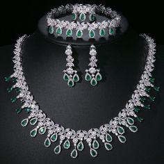 Experience the epitome of elegance with our Luxury Emerald Bridal Jewelry Sets. These exquisite pieces feature captivating green emerald-like stones crafted from AAA Cubic Zirconia, meticulously set in a pendant necklace and coordinating earrings. Designed to enhance your allure at any special occasion, from weddings to glamorous parties and elegant dinner events, these sets embody a timeless sophistication. Style: TRENDY Shape\pattern: Geometric Occasion: Wedding Metals Type: Copper Alloy Mater Teardrop Emerald Diamond Necklace For Wedding, Fine Jewelry Green Bridal Necklace As Gift, Dazzling Green Jewelry For Gift, Dazzling Green Jewelry For Gifts, Dazzling Green Emerald Necklace, Formal Green Emerald Diamond Necklace, Emerald Gemstone Jewelry Sets For Anniversary, Green Fine Jewelry Sets For Anniversary, Anniversary Emerald Gemstone Jewelry Sets