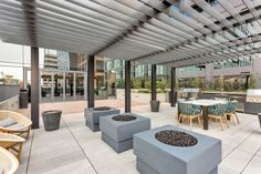 an outdoor kitchen and dining area is shown in this modern style setting with pergolated roofing