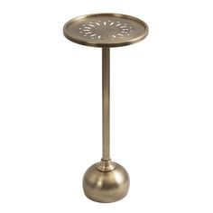 a metal table with a circular design on the top and bottom, in an antique brass finish