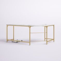 a table with a glass top and metal frame on the bottom, in front of a white background