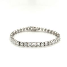 "A 12-carat diamond box style tennis bracelet set in 18K white gold. Box closure with double safety latches. Double rhodium plated for long-lasting brilliance and shine. 7 inches, 4.75mm width, and 36 round brilliant cut diamonds. 100% waterproof and meticulously made with a strong closure for daily wear. The stones are CVD lab-grown diamonds of F-G color and VVS2 clarity. Most lab-grown diamond tennis bracelets are made with HPHT diamonds, but these diamonds are made via CVD (Chemical Vapor Dep Round Crystal Tennis Bracelet With Diamond Cut, White Round Cut Diamond Tennis Bracelet, White Round Tennis Bracelet With Prong Setting, Luxury White Round Cut Tennis Bracelet, Luxury Lab Grown Diamond Tennis Bracelet, Round Cut, Diamond Box, Diamond Tennis Bracelet, White Gold Set, Cvd Diamond