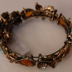 Amber Colors Accessories For Shifting, Adjustable Costume Jewelry Bangle As Gift, Stretch Bangle Bracelet, Adjustable Costume Jewelry Bangle For Gifts, Elegant Brown Metal Cuff Bracelet, Adjustable Jeweled Cuff Bracelet For Formal Occasions, Adjustable Jeweled Cuff Bracelet For Formal Events, Adjustable Formal Cuff Bracelet With Jewels, Formal Adjustable Jeweled Cuff Bracelet