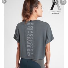 Athleta Nwt Legend Short Sleeve Short Tee “Break Record Barriers” Color: Bali Green Brand New With Tag $54.00 Size: 2x Oversized Fit, Super Soft On Body, Special Allyson Felix Graphic, Anti-Oder Technology, Moisture Wicking, Fair Trade Certified. Underarm To Underarm: 31", Back Of Neck To Hem: 23" 75% Polyester, 19% Lyocell, 7% Spandex, Super Soft!! Color: Bali Green Smoke And Pet Free Home Gray Short Sleeve Tops For Light Exercise, Gray Crew Neck Activewear For Light Exercise, Gray Go-dry Tops For Light Sports, Sportswear Activewear With Graphic Print For Training, Relaxed Fit Athleisure Tops For Gym, Athleisure T-shirt For Light Exercise, Athleisure T-shirt For Light Sports, Gray Functional Athletic Fit Tops, Gray Go-dry Sportswear Top