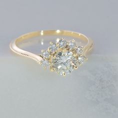 a yellow gold engagement ring with three diamonds