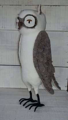 an owl is standing on its hind legs