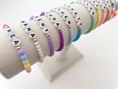 one colorful beaded name bracelet bracelets are made on a durable stretch elastic cord please refer to our sizing guide before purchasing Multicolor Name Bracelet With Letter Beads And Round Beads, Multicolor Name Bracelet With Round Letter Beads, Multicolor Name Bracelet With Letter Beads, Trendy Beaded Bracelets For Birthdays, Trendy Custom Name Jewelry With Round Beads, Trendy Beaded Bracelet For Birthday, Trendy White 8mm Beads, Adjustable Name Bracelet With Colorful Beads, Multicolor 8mm Beads Name Bracelet For Friendship