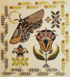 a cross stitch pattern with moths and flowers