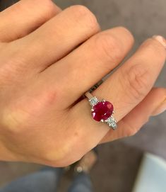 A 1.70 ct. oval cut red ruby set between 2 round brilliant cut diamonds, 0.30 carats total and GH/VS quality and set in 14K white gold. Ring size 6, can be resized upon request. Diamond Three Stone Ring, Ruby Set, 3 Stone Ring, 3 Stone Rings, Three Stone Ring, Rings Diamond, Ruby Diamond, Red Ruby, Three Stone Rings