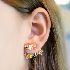 "Shhhhh...The fox is sleeping. 🦊 Hand painted Enamel Fox FrontBack Earrings I've thoughtfully designed these earrings with versatility in mind. You can enjoy wearing them in two unique ways - sport the entire front-and-back design for a fun and full look, or you can simply wear the front part for a minimalist, yet equally charming effect. They're guaranteed to brighten up your style! Furthermore, I prioritize the comfort of people with sensitive skin. My earrings are hypoallergenic and nickel-free, featuring posts made from surgical grade stainless steel. Rest assured, you can wear them with comfort and confidence.\" Details   ◆ Sleeping orange fox at front / A branch with orange, yellow leaves and pinecone at back. ◆ Sleeping white fox at front / A branch with white, glitter leaves and p Fox Themed Outfit, Gifts To Buy, Fox Earrings, Fox Jewelry, Glitter Leaves, Jacket Earrings, Winter Earrings, Front Back Earrings, Orange Fox