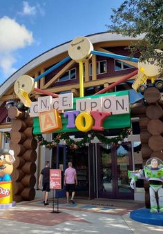 the entrance to disney's once upon toy story land with characters from pixama and buzz lightyear