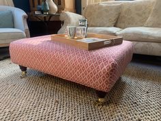 a coffee table sitting on top of a rug in front of a couch and chair